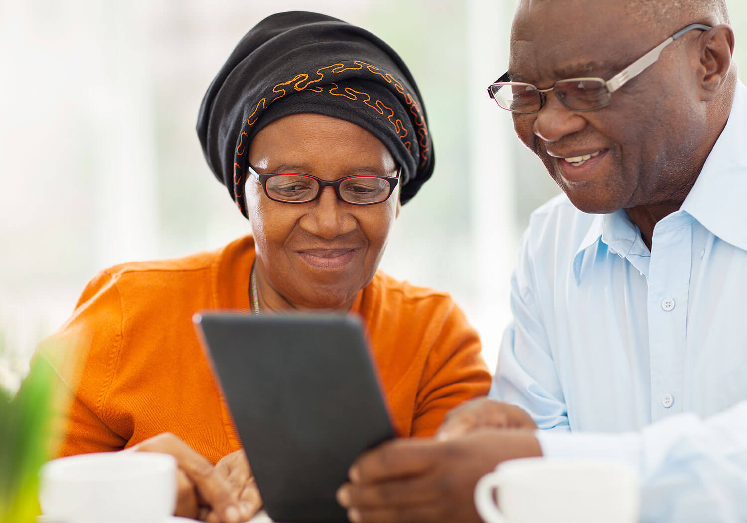 Older African couple browsing tablet